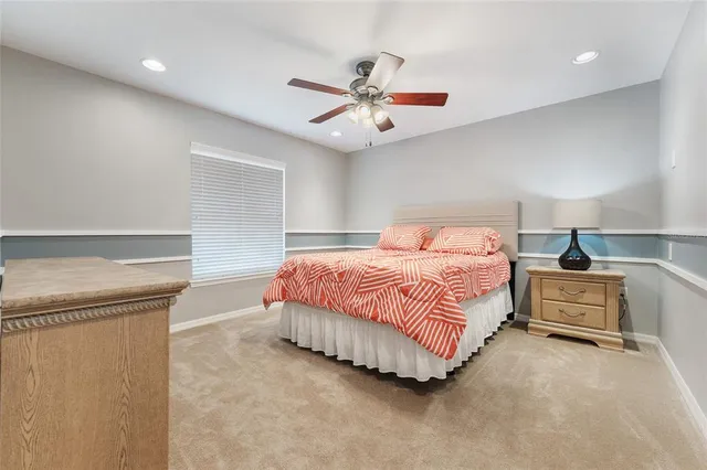 a bedroom with a bed and ceiling fan