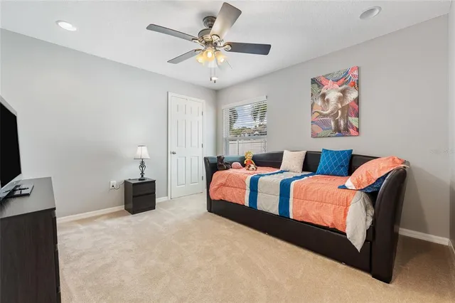 a spacious bedroom with a bed and a chandelier