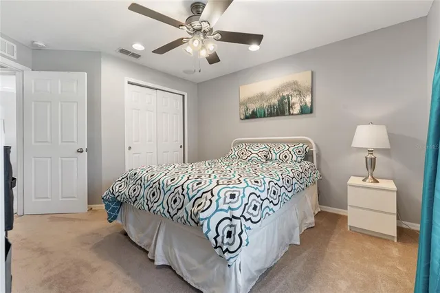 a bedroom with a large bed and a chandelier