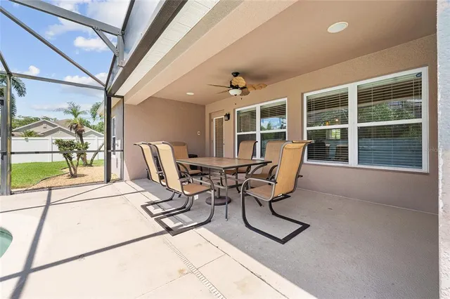 a work room with furniture and floor to ceiling windows