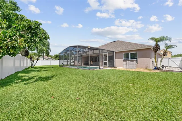 a view of a house with a backyard