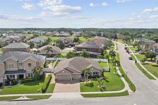 an aerial view of a house with garden space and street view