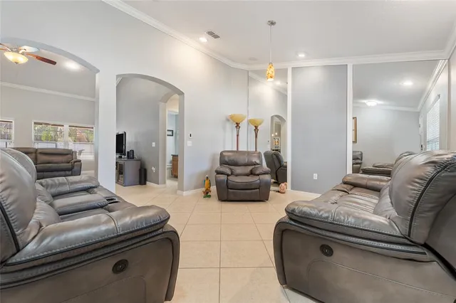 a living room with furniture and a mirror