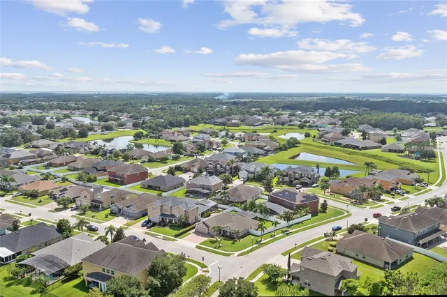 an aerial view of residential building with green space