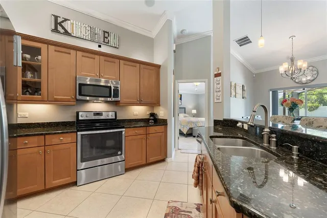 a large kitchen with granite countertop a sink and a stove