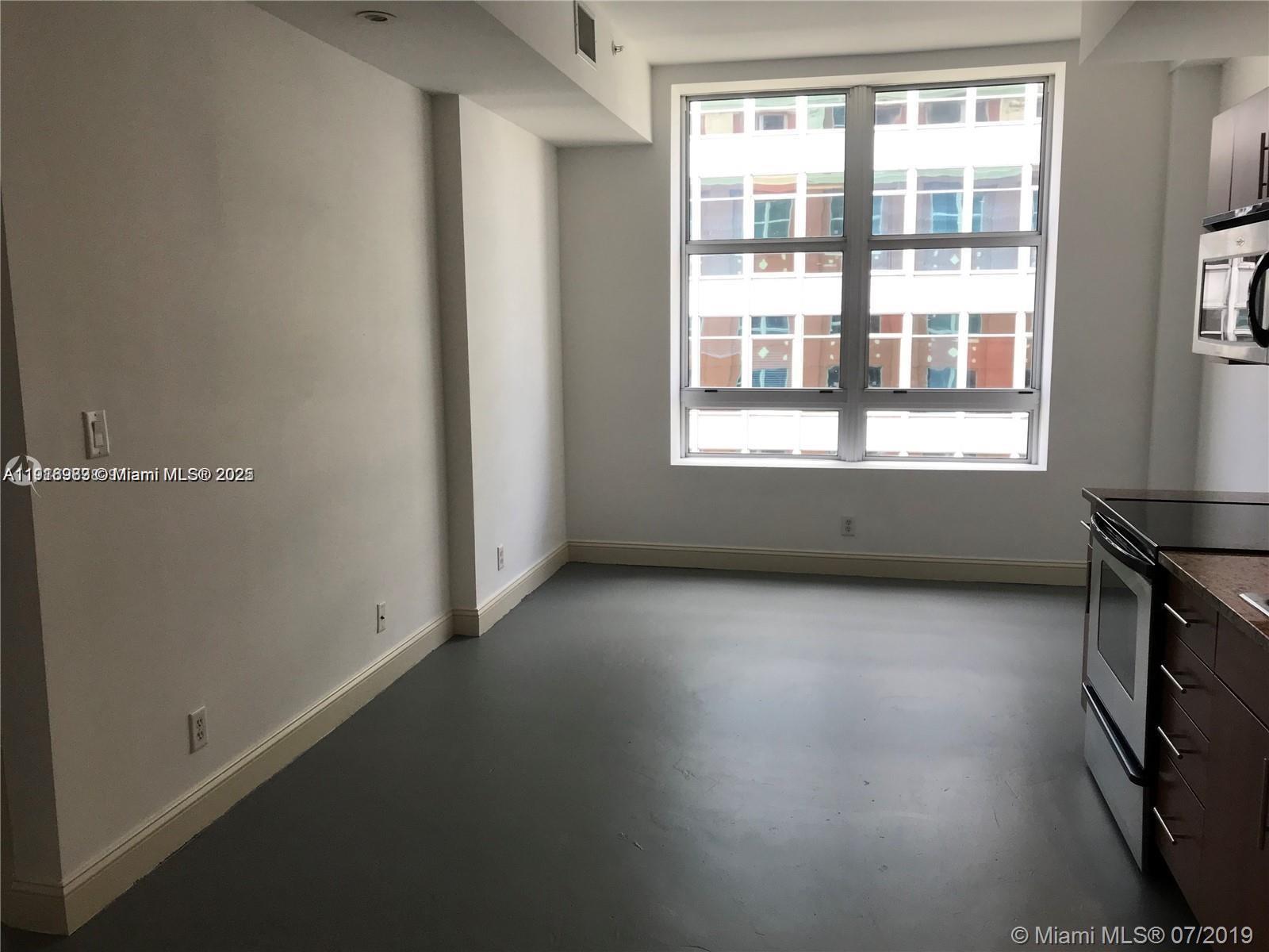 111 East Flagler Street, Unit 803 Miami, FL 33131 - Photo 11 of 16 an empty room with windows