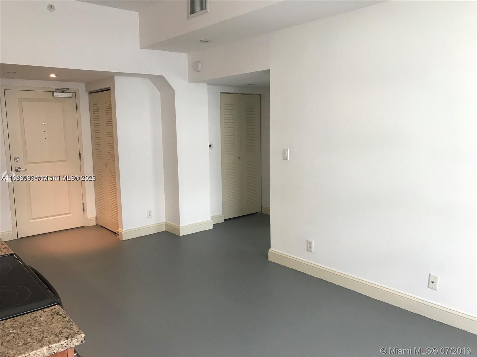 111 East Flagler Street, Unit 803 Miami, FL 33131 - Photo 3 of 16 an empty room with closet