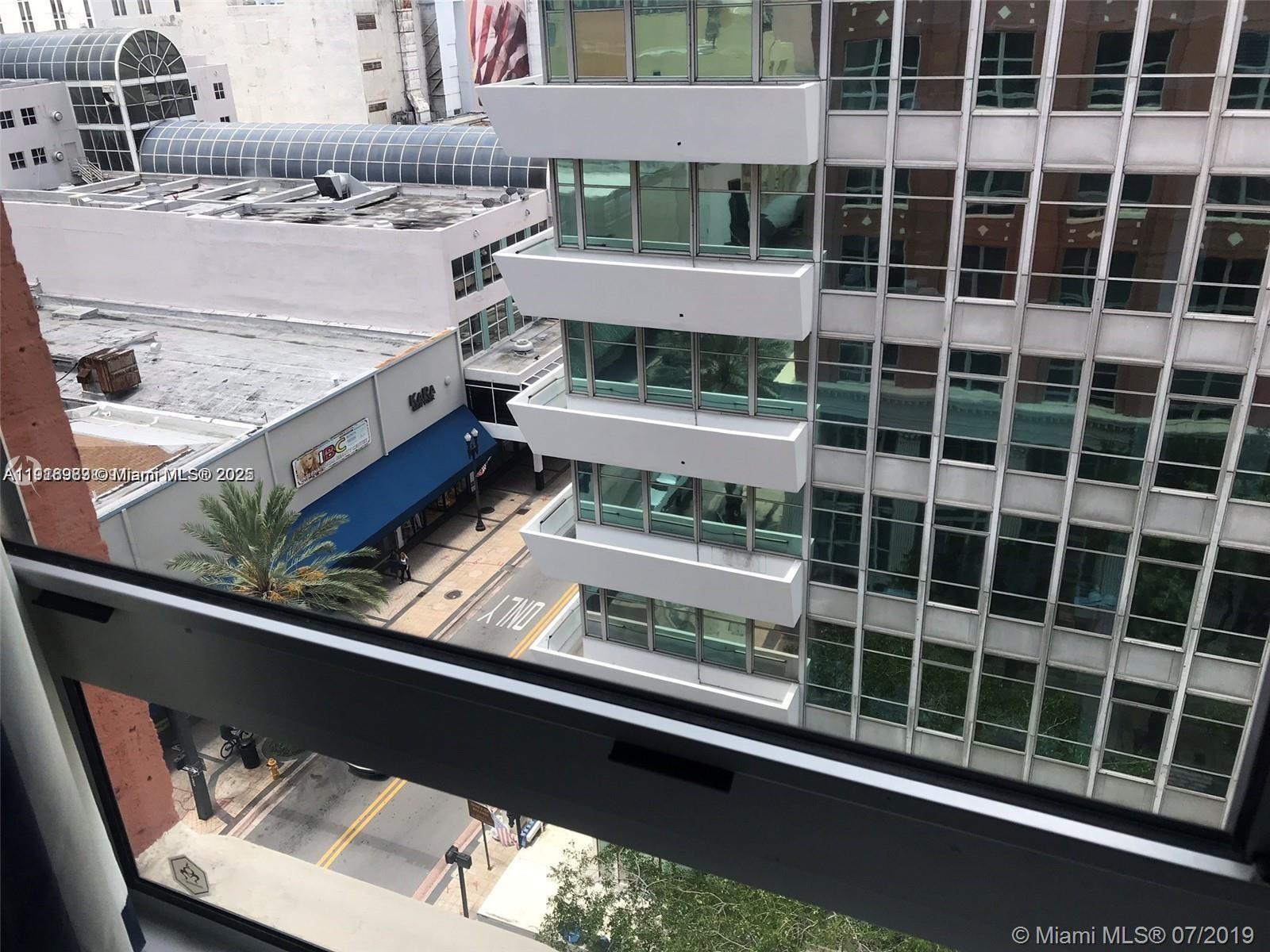 111 East Flagler Street, Unit 803 Miami, FL 33131 - Photo 7 of 16 a view of a balcony with a floor to ceiling window