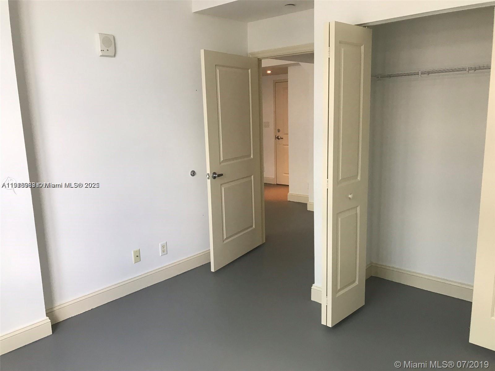 111 East Flagler Street, Unit 803 Miami, FL 33131 - Photo 8 of 16 an empty room with a door