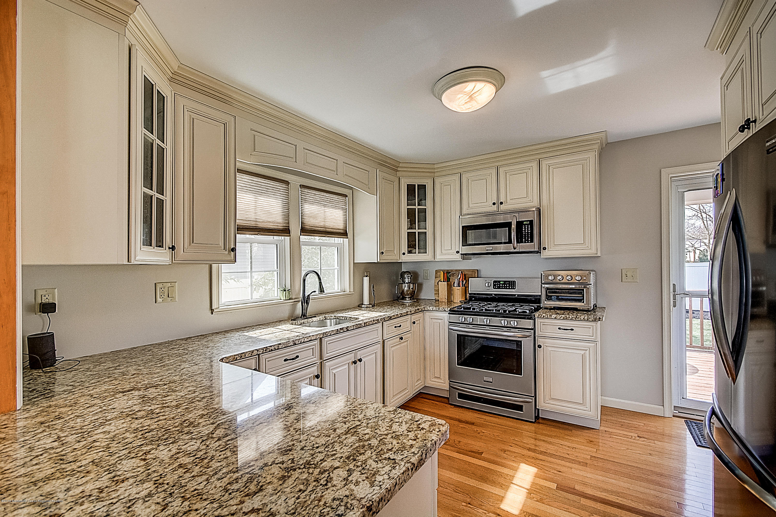 2302 Oak Tree Road Point Pleasant, NJ 08742 - Photo 12 of 48 a kitchen with stainless steel appliances granite countertop a stove a sink dishwasher a refrigerator and a microwave oven with white cabinets