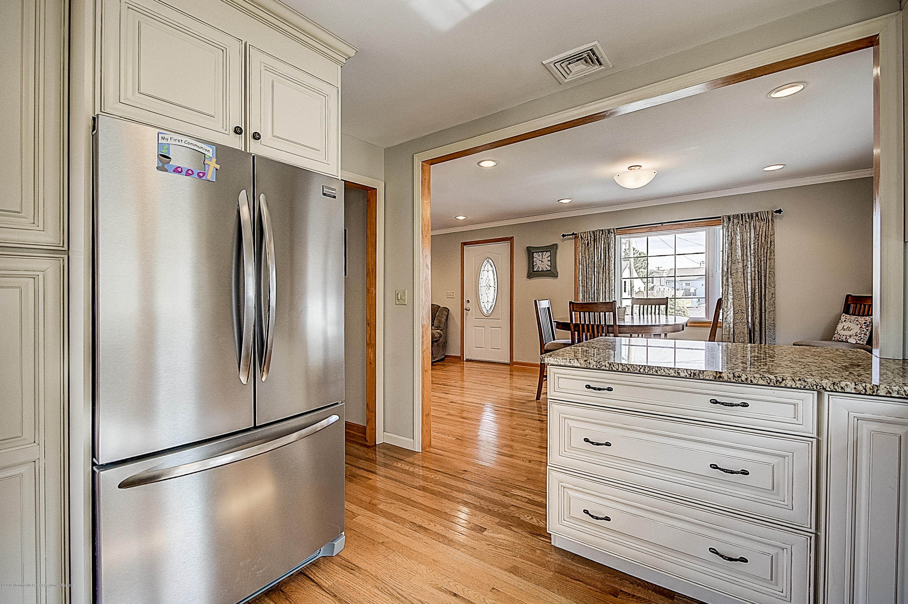 2302 Oak Tree Road Point Pleasant, NJ 08742 - Photo 15 of 48 a kitchen with a refrigerator and white cabinets
