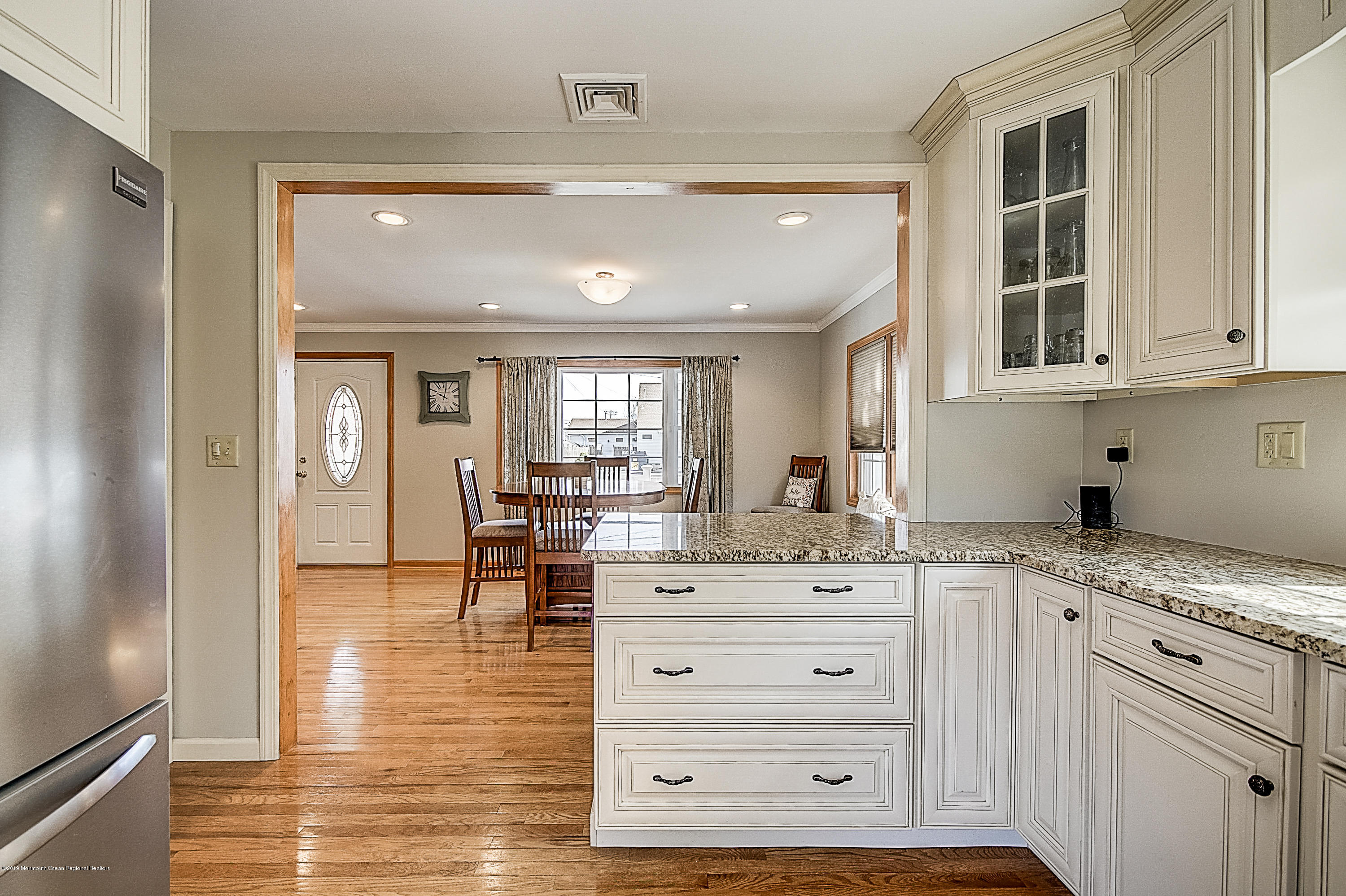 2302 Oak Tree Road Point Pleasant, NJ 08742 - Photo 16 of 48 a view of cabinets a island with granite countertop a living room