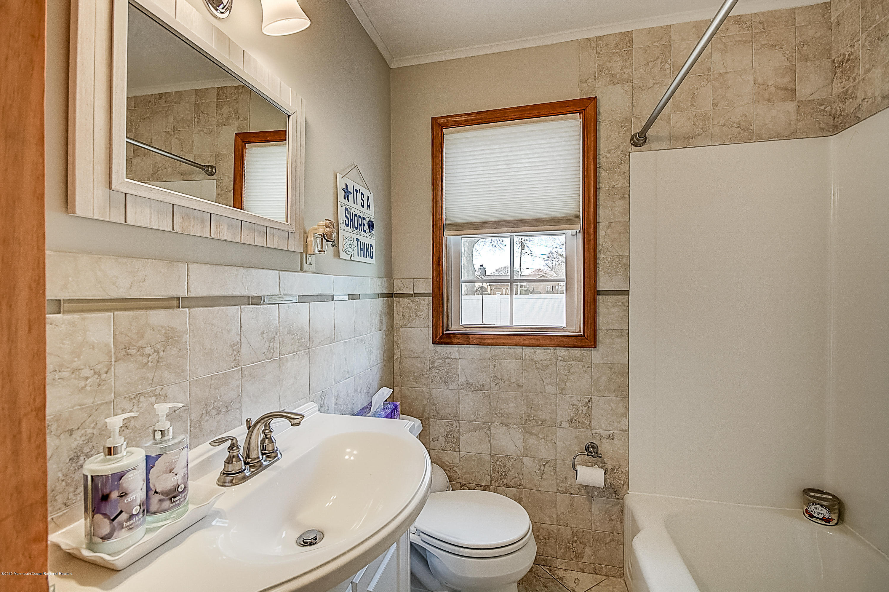 2302 Oak Tree Road Point Pleasant, NJ 08742 - Photo 17 of 48 a bathroom with a sink a toilet and shower