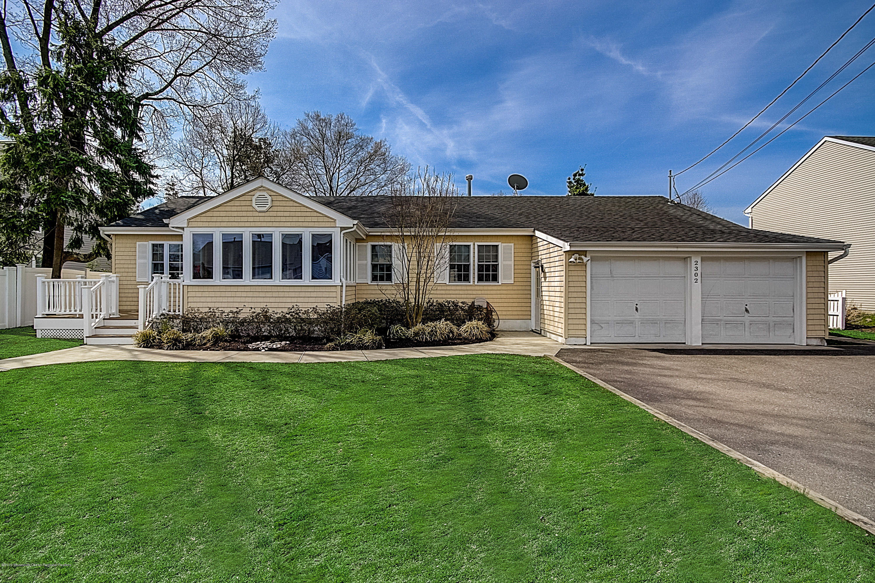 2302 Oak Tree Road Point Pleasant, NJ 08742 - Photo 2 of 48 a front view of a house with a garden