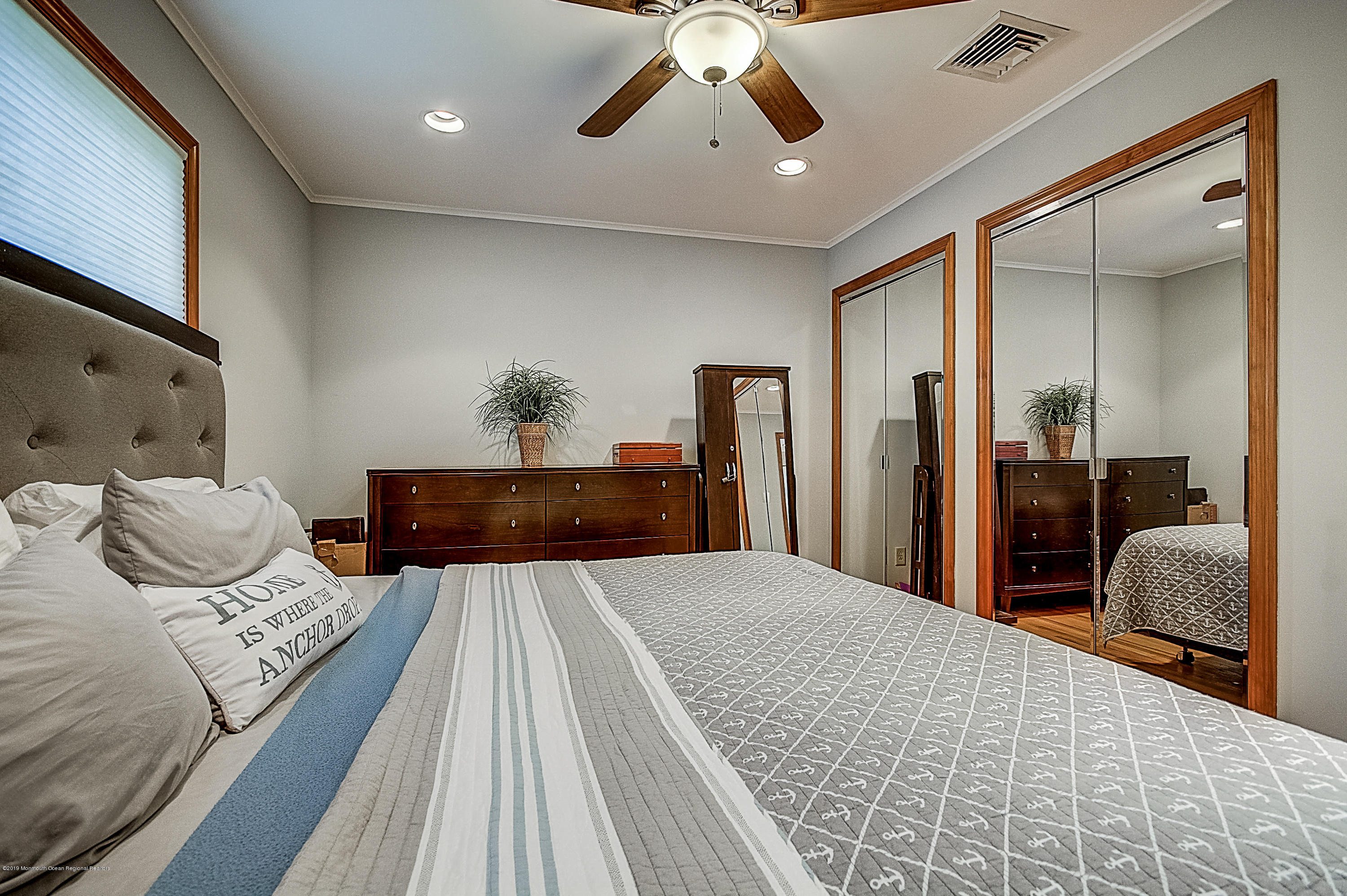 2302 Oak Tree Road Point Pleasant, NJ 08742 - Photo 22 of 48 a bedroom with a large bed and a chandelier