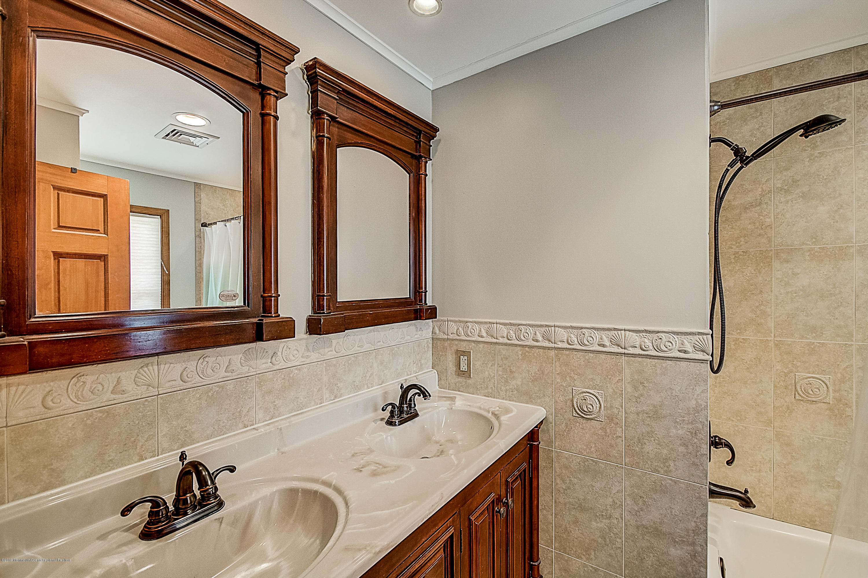 2302 Oak Tree Road Point Pleasant, NJ 08742 - Photo 23 of 48 a bathroom with a sink and a mirror
