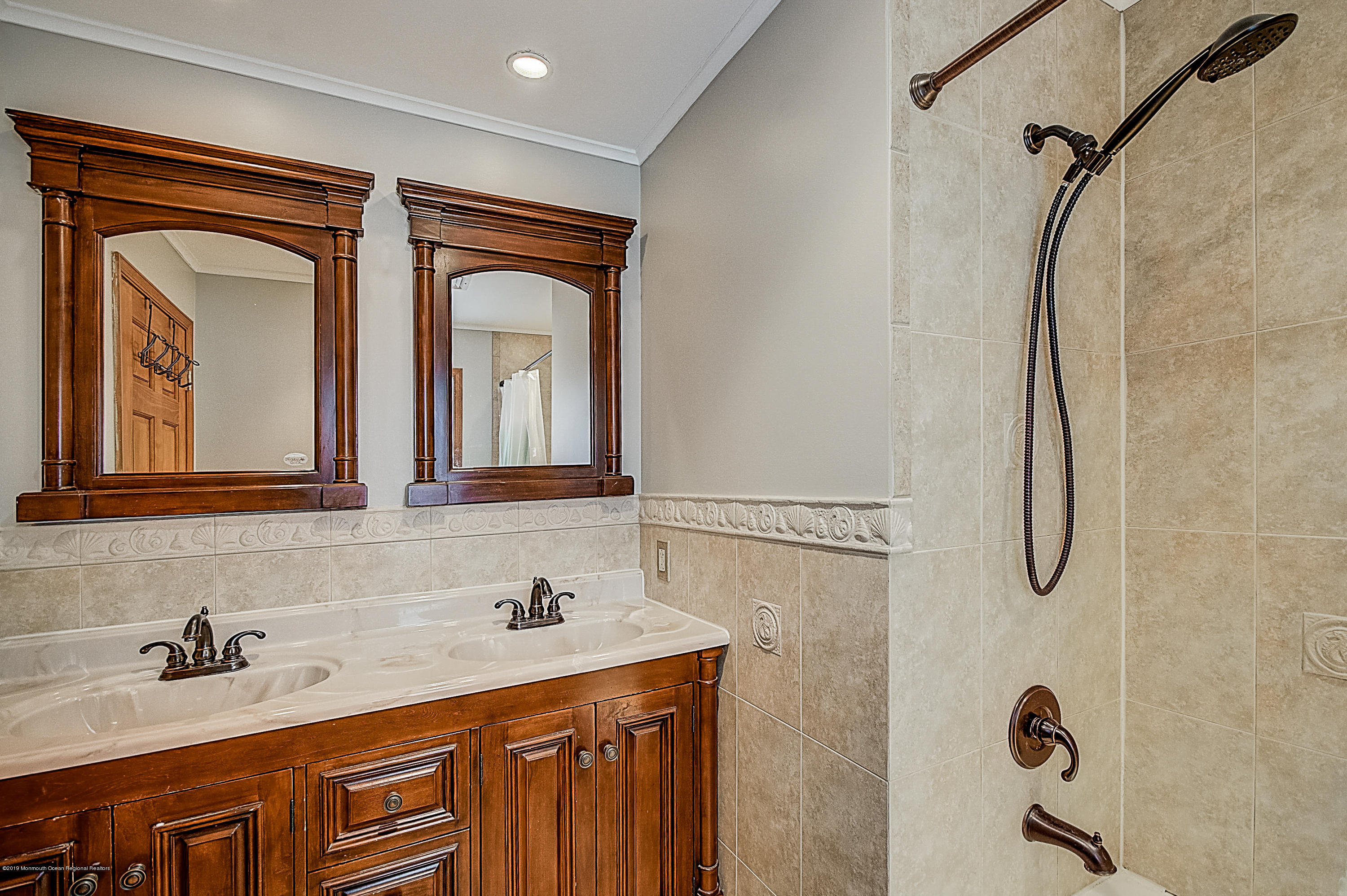 2302 Oak Tree Road Point Pleasant, NJ 08742 - Photo 25 of 48 a bathroom with a granite countertop sink a mirror and a shower