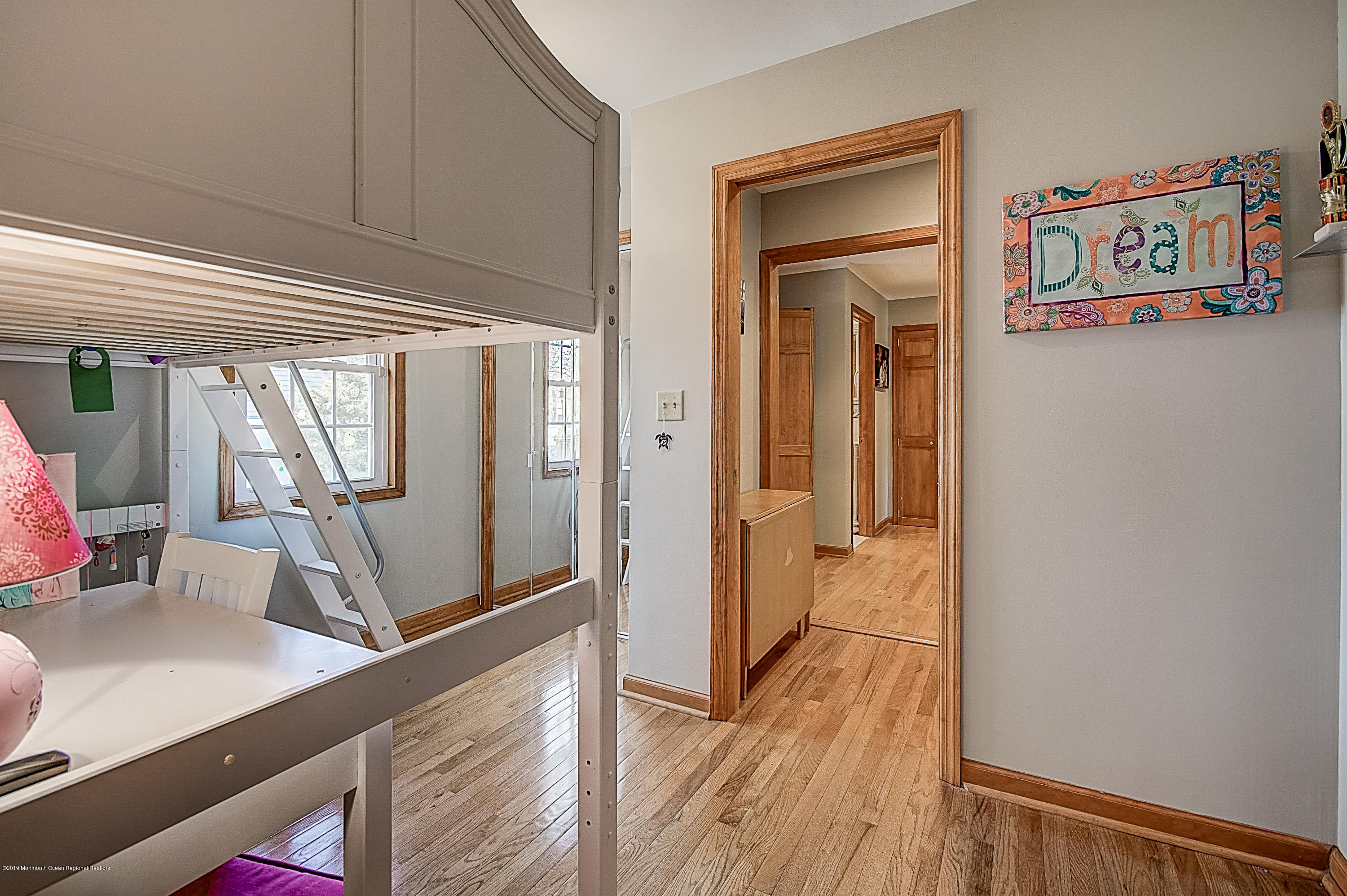2302 Oak Tree Road Point Pleasant, NJ 08742 - Photo 26 of 48 a view of a hallway with wooden floor and furniture