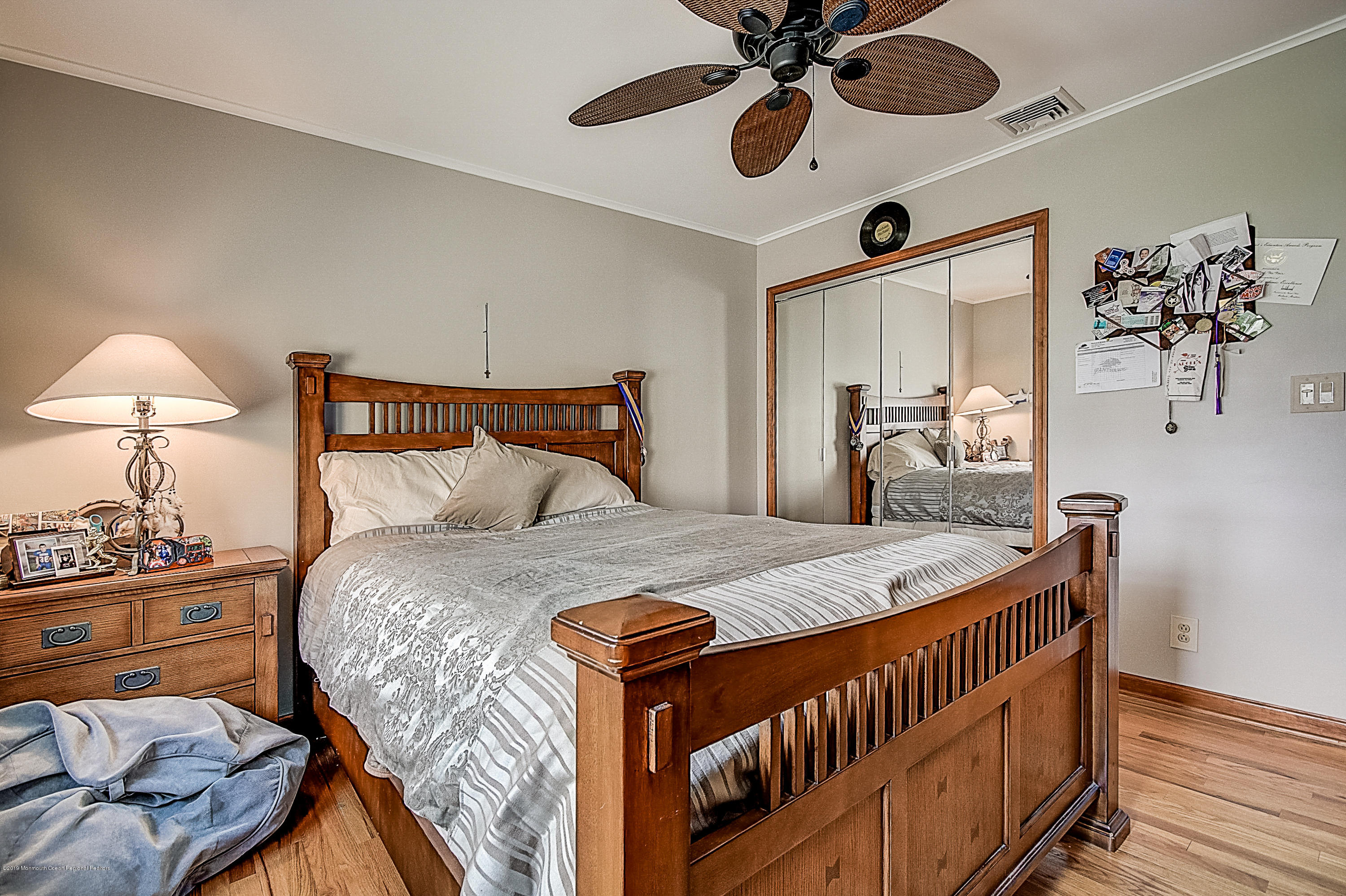 2302 Oak Tree Road Point Pleasant, NJ 08742 - Photo 32 of 48 a bedroom with a bed and a chandelier