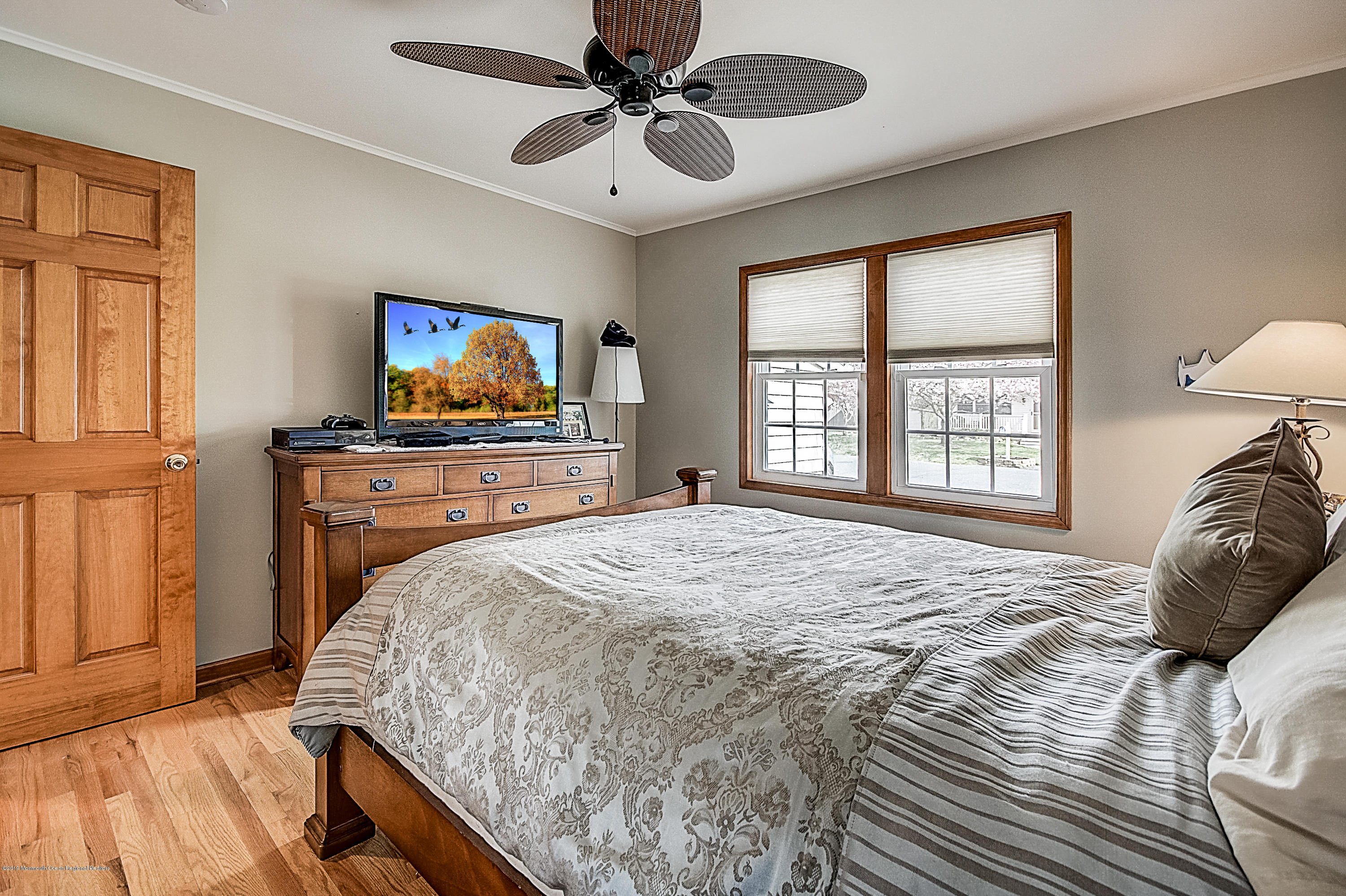 2302 Oak Tree Road Point Pleasant, NJ 08742 - Photo 34 of 48 a bedroom with a bed and a flat screen tv