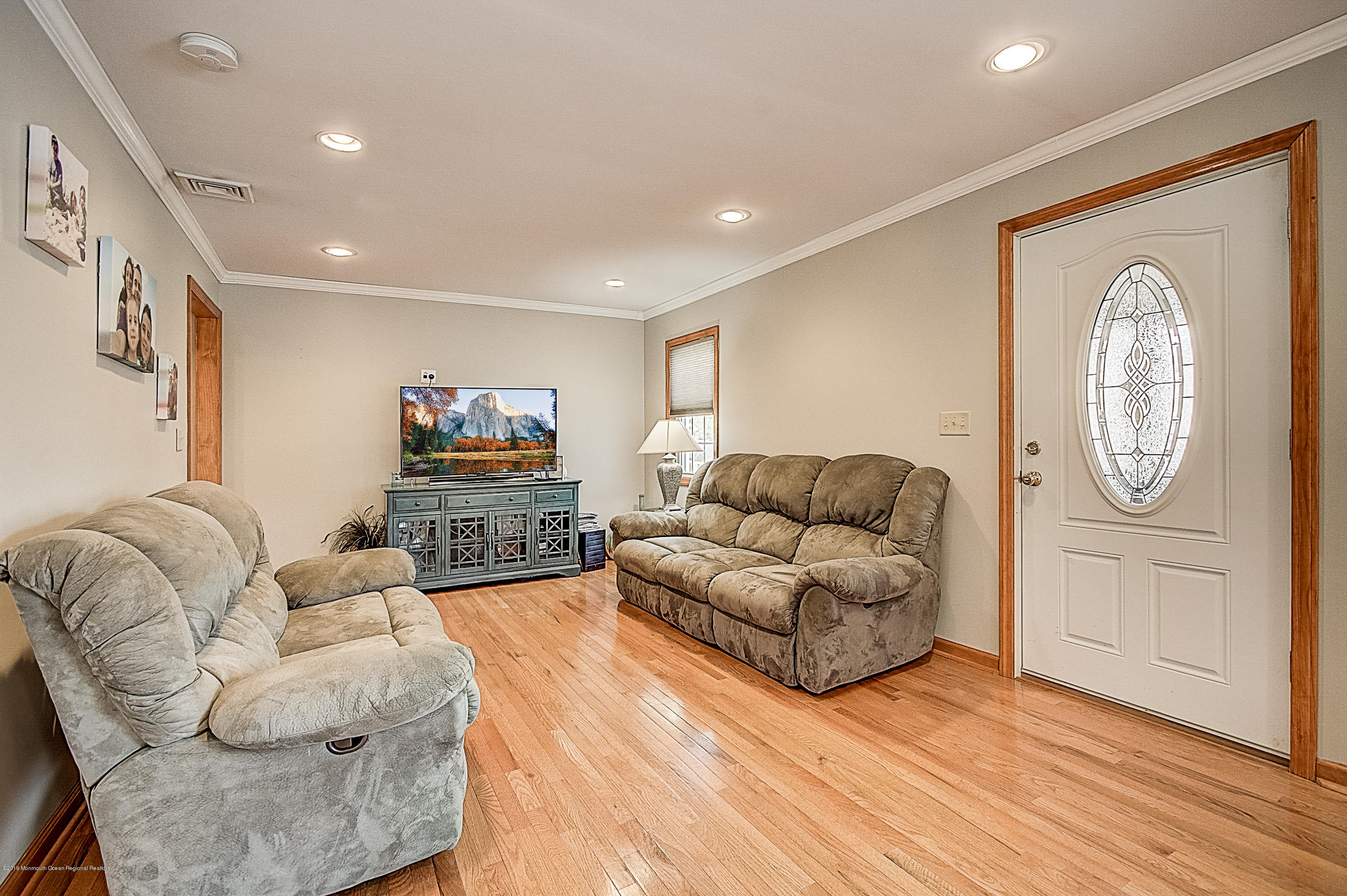 2302 Oak Tree Road Point Pleasant, NJ 08742 - Photo 6 of 48 a living room with furniture a couch and wooden floor
