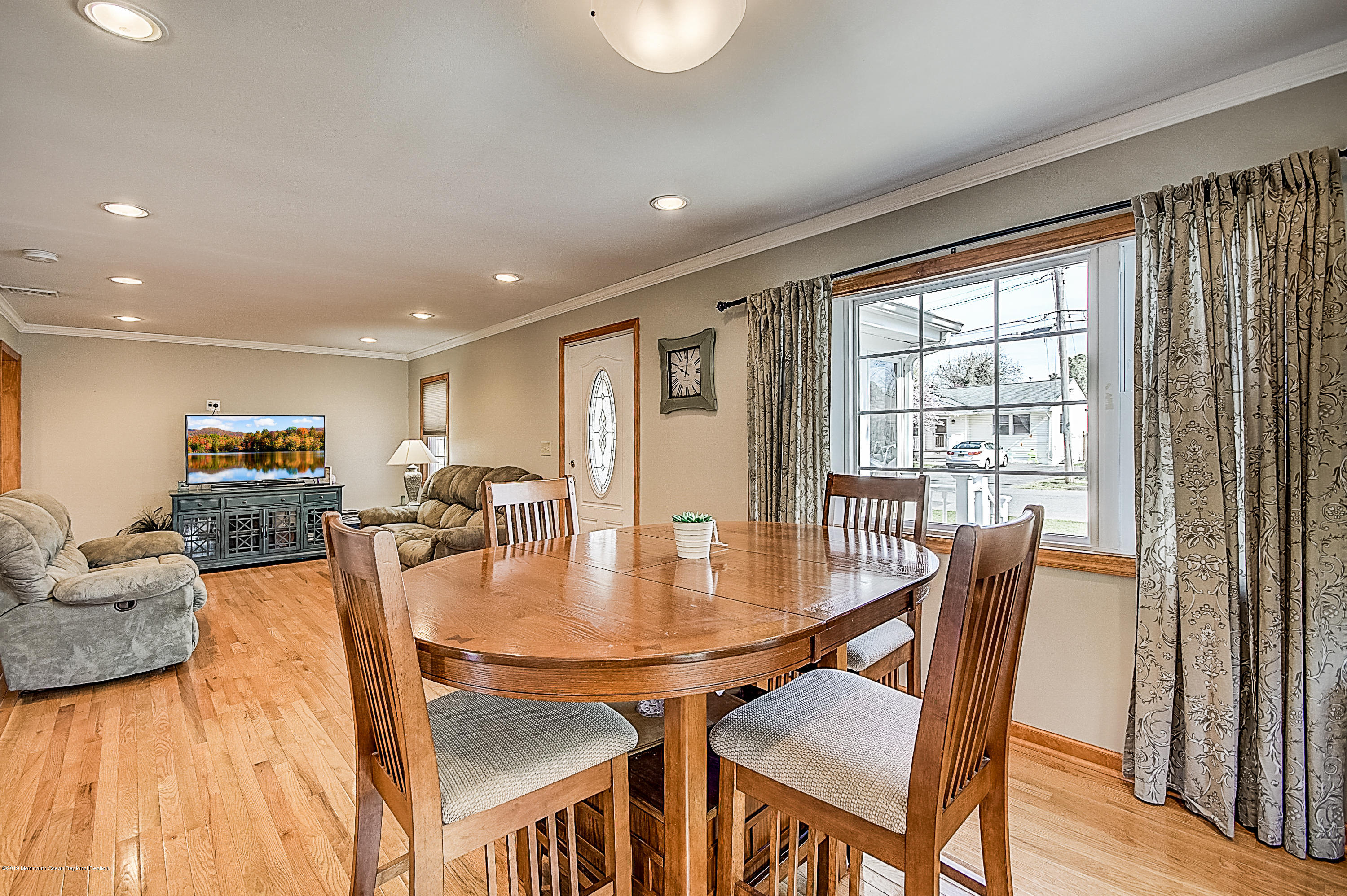 2302 Oak Tree Road Point Pleasant, NJ 08742 - Photo 10 of 48 a dining room with furniture a window and wooden floor