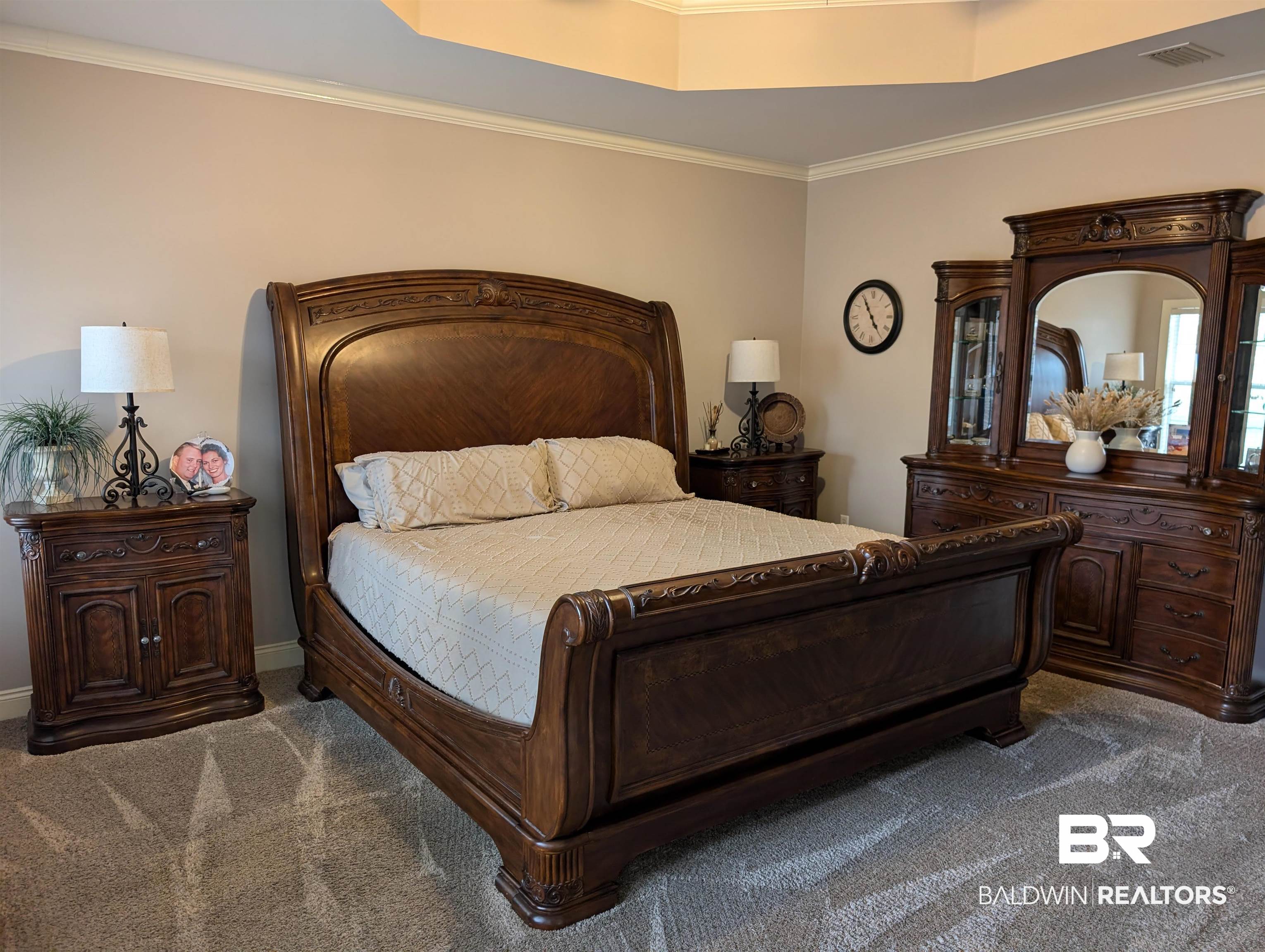 506 Old Castleberry Road Brewton, AL 36426 - Photo 9 of 14 Carpeted bedroom featuring a raised ceiling, ornamental molding, and visible vents