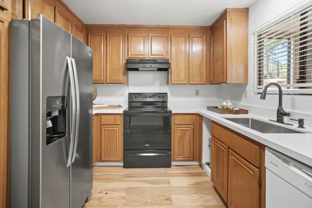 a kitchen with a refrigerator and a sink