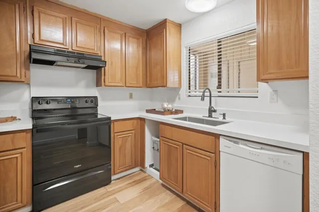 a kitchen with granite countertop stainless steel appliances and cabinets