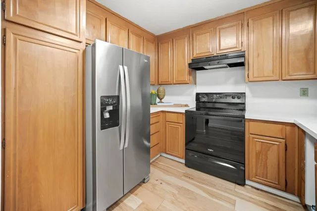 a kitchen with stainless steel appliances a refrigerator and cabinets