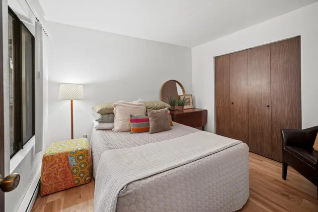 a bedroom with a bed and wooden floor