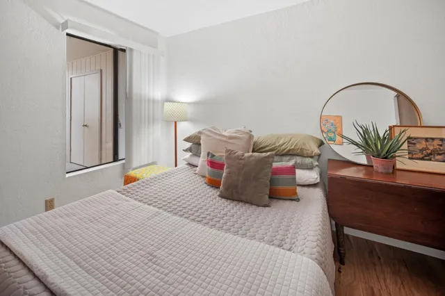 a bedroom with a bed and a potted plant