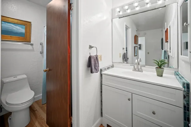 a bathroom with a toilet sink and mirror