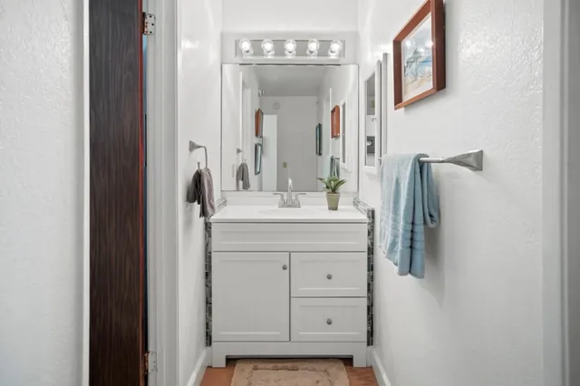 a bathroom with a sink vanity and a mirror