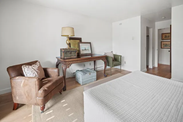 a bedroom with furniture and a mirror