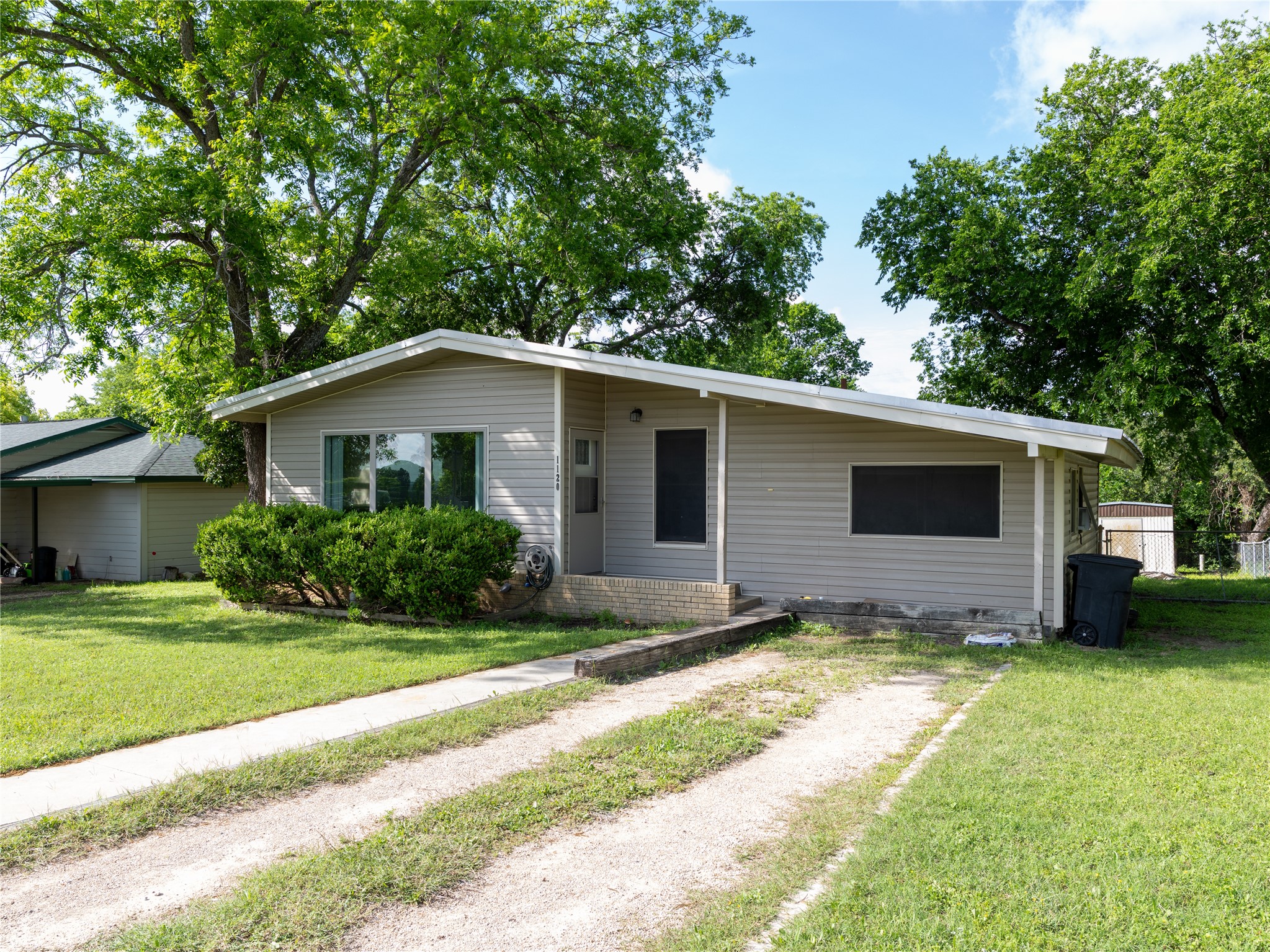 1120 Nix Road Lampasas, TX 76550 - Photo 4 of 31 a view of a house with a yard plants and a large tree