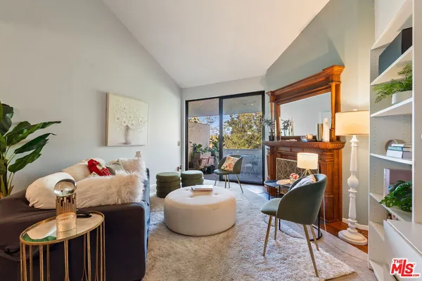a living room with furniture and a floor to ceiling window