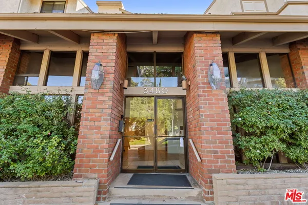 a view of a balcony with chair and white walls