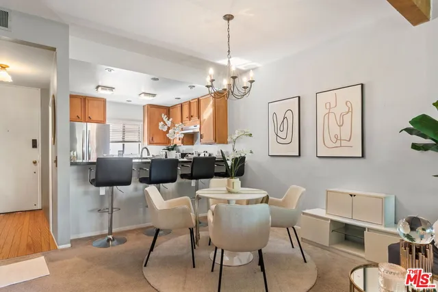a view of a dining room with furniture and chandelier