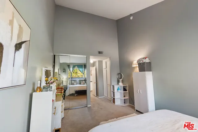 a bedroom with furniture and a window