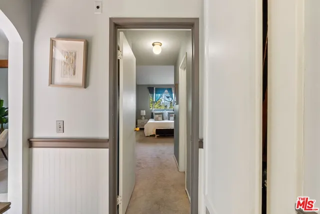 a view of a hallway with a livingroom and a livingroom with furniture