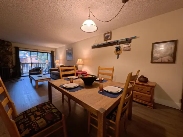 a dining room with furniture and wooden floor