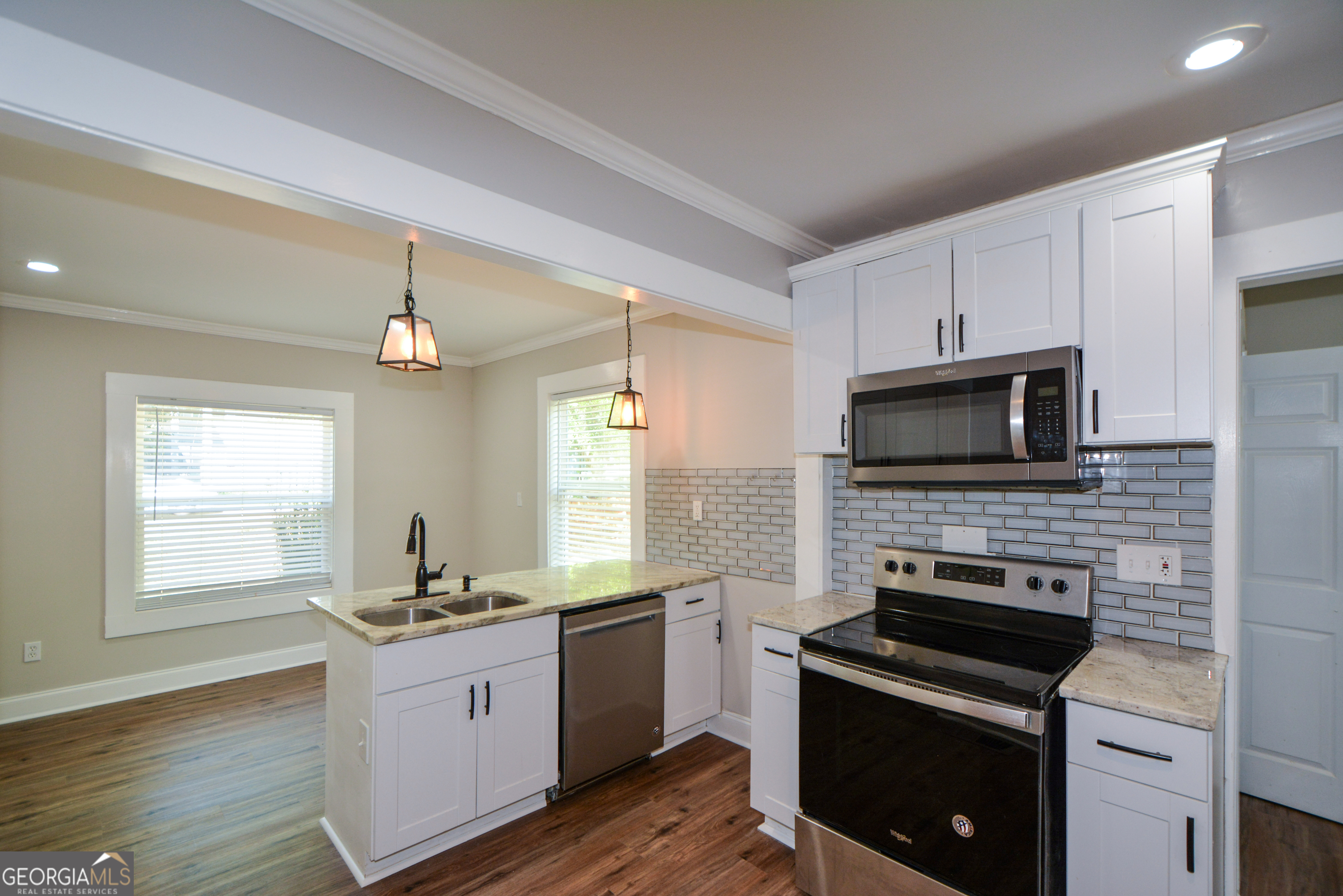 3164 Harris Drive East Point, GA 30344 - Photo 16 of 40 a kitchen with granite countertop a stove sink and microwave