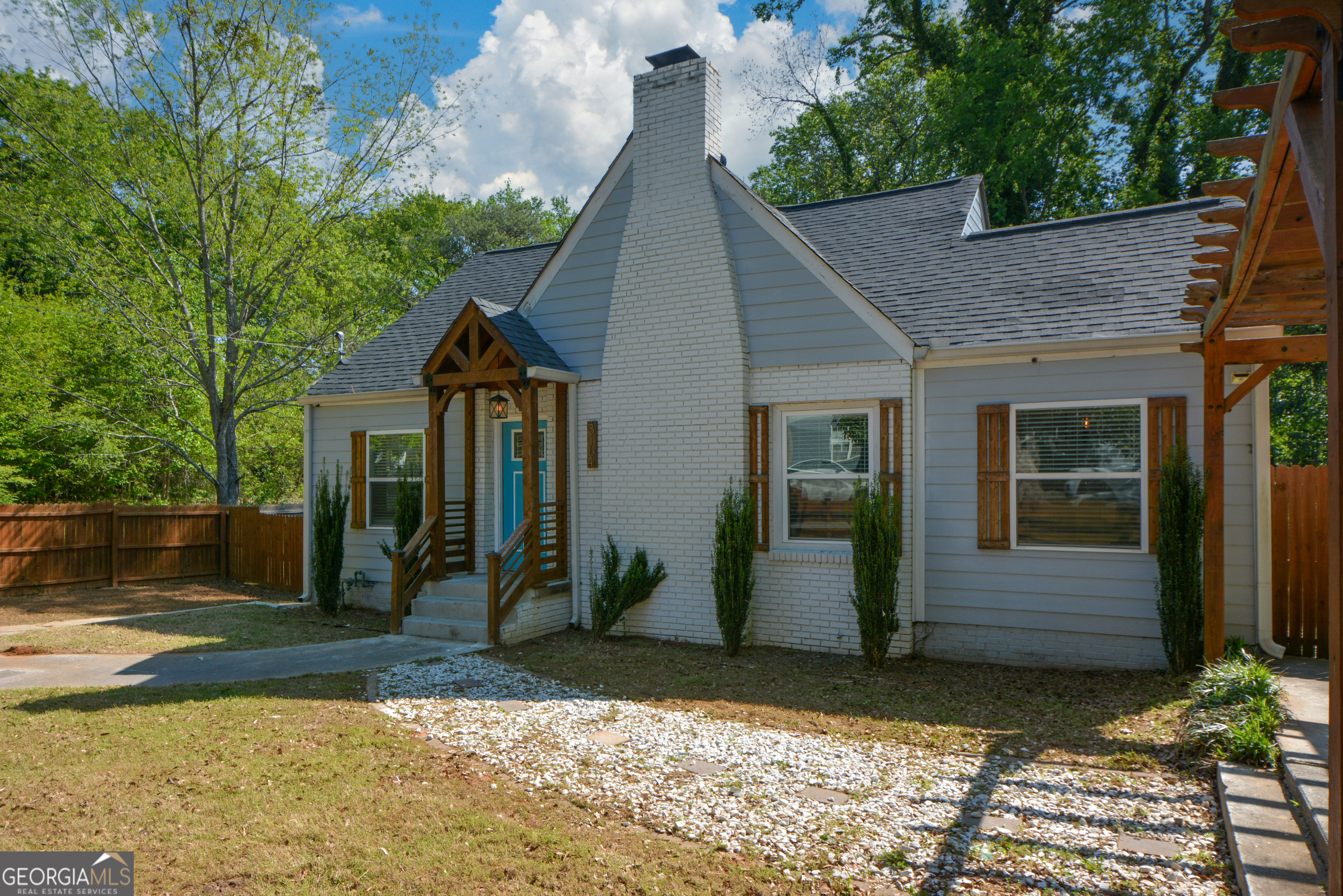 3164 Harris Drive East Point, GA 30344 - Photo 2 of 40 a front view of a house with garden