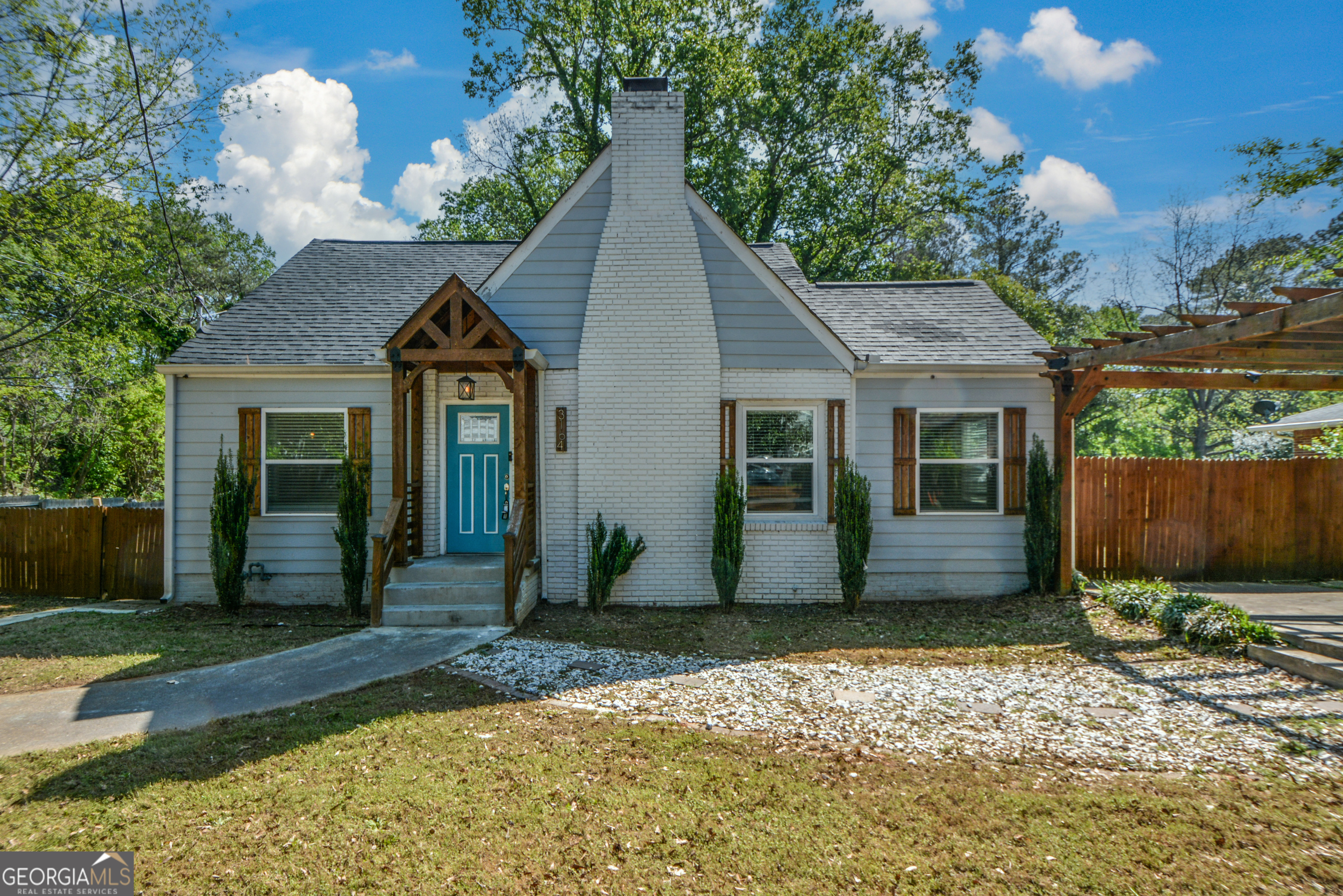 3164 Harris Drive East Point, GA 30344 - Photo 3 of 40 a front view of a house with a yard and potted plants