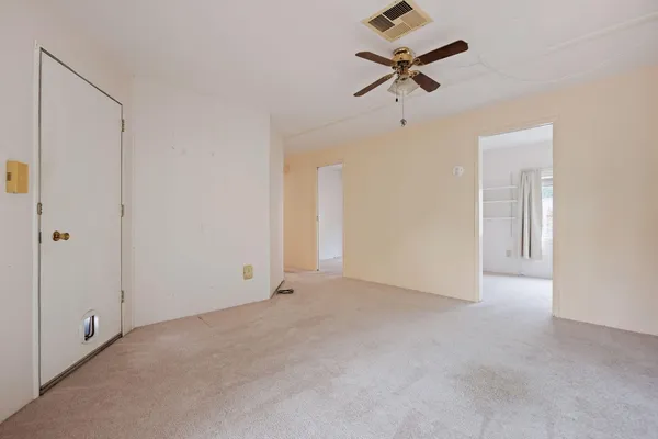 an empty room with ceiling fan