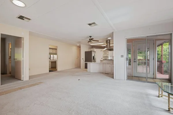 a view of empty room with furniture and refrigerator