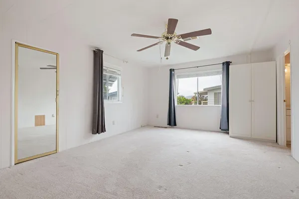 a view of a big room with closet and windows