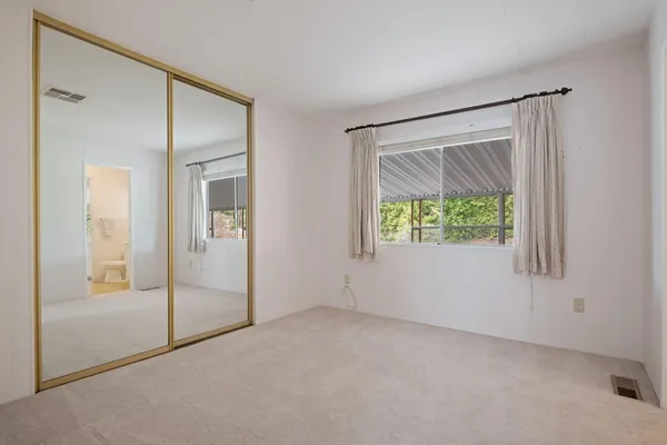 an empty room that has a glass door and shower