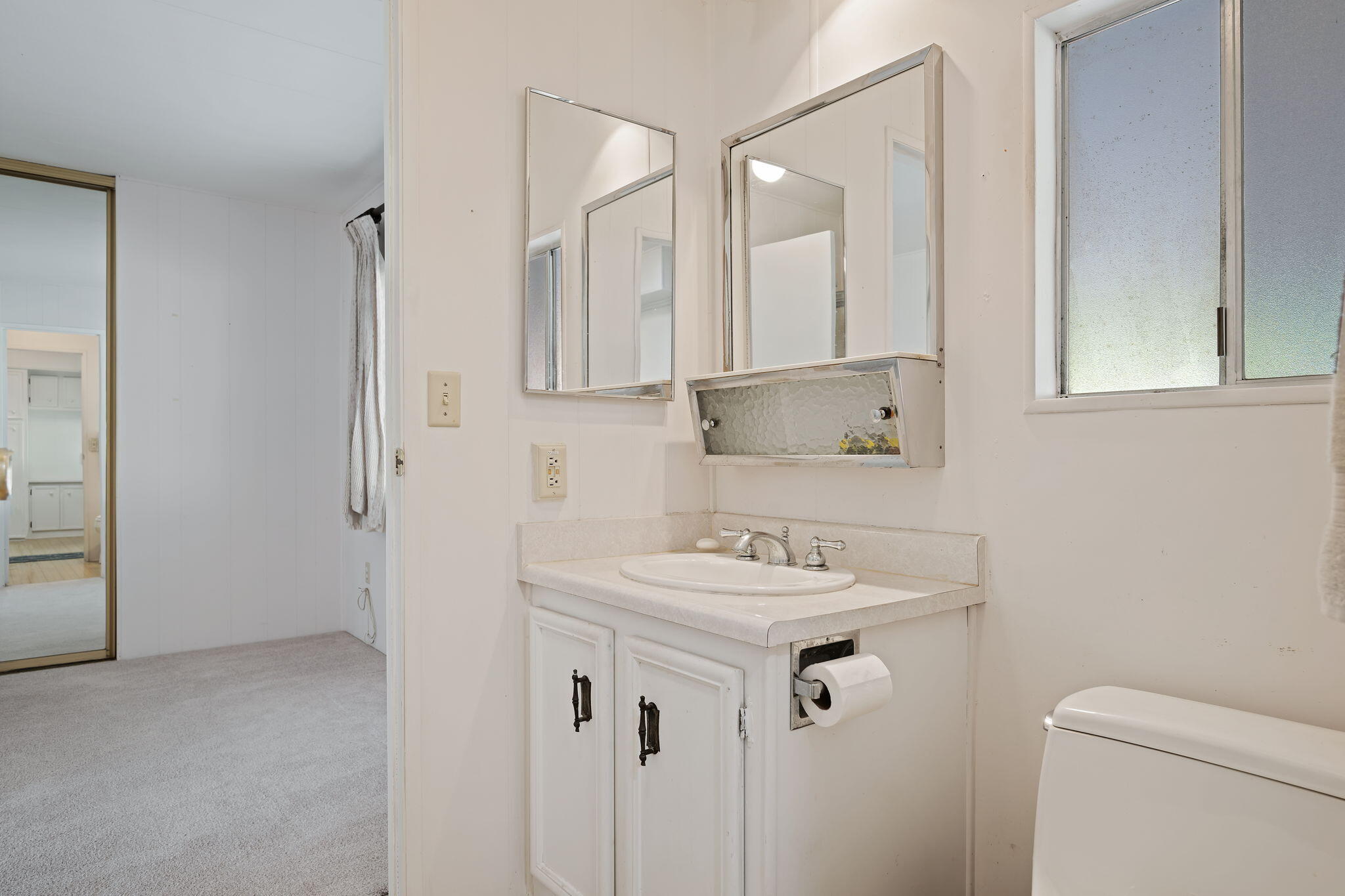 340 Old Mill Road, Unit 127 Santa Barbara, CA 93110 - Photo 21 of 33 a bathroom with a sink toilet vanity and mirror